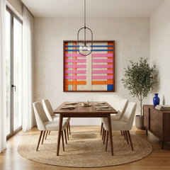 Square colorful textured wool art creating a bright focal point in a contemporary dining room with a round wooden table and light beige chairs.