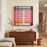 California Afterglow framed textured tapestry hanging beautifully above a mid-century wooden sideboard in a sunlit, modern living room setting.