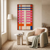 A cozy living room featuring the California Rhythm hand-woven wool tapestry mounted on a wall above a comfortable armchair.
