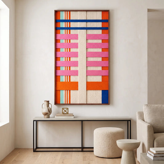 The California Rhythm hand-woven wool tapestry hangs elegantly above a minimalist console table in a bright modern home.