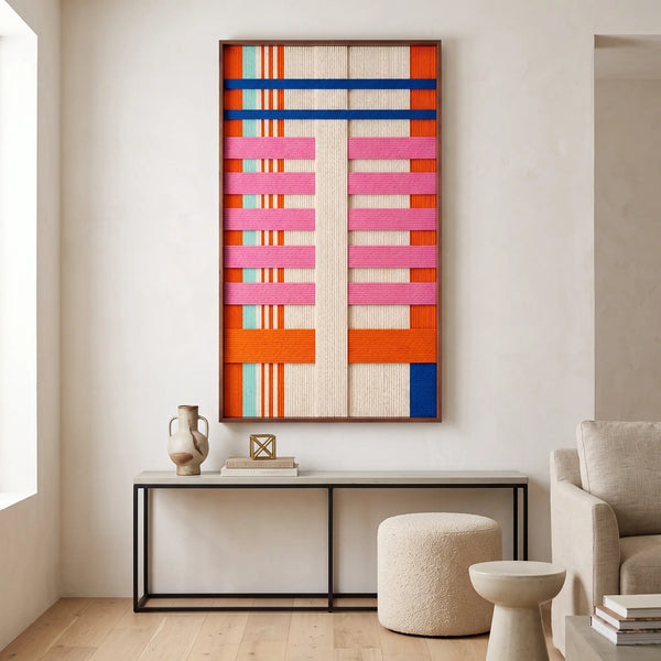 The California Rhythm hand-woven wool tapestry hangs elegantly above a minimalist console table in a bright modern home.