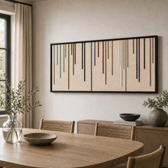 The Chromatic Rain colorful hand-woven wool tapestry provides a striking focal point over a wooden dining table in a contemporary, neutral-toned dining room.