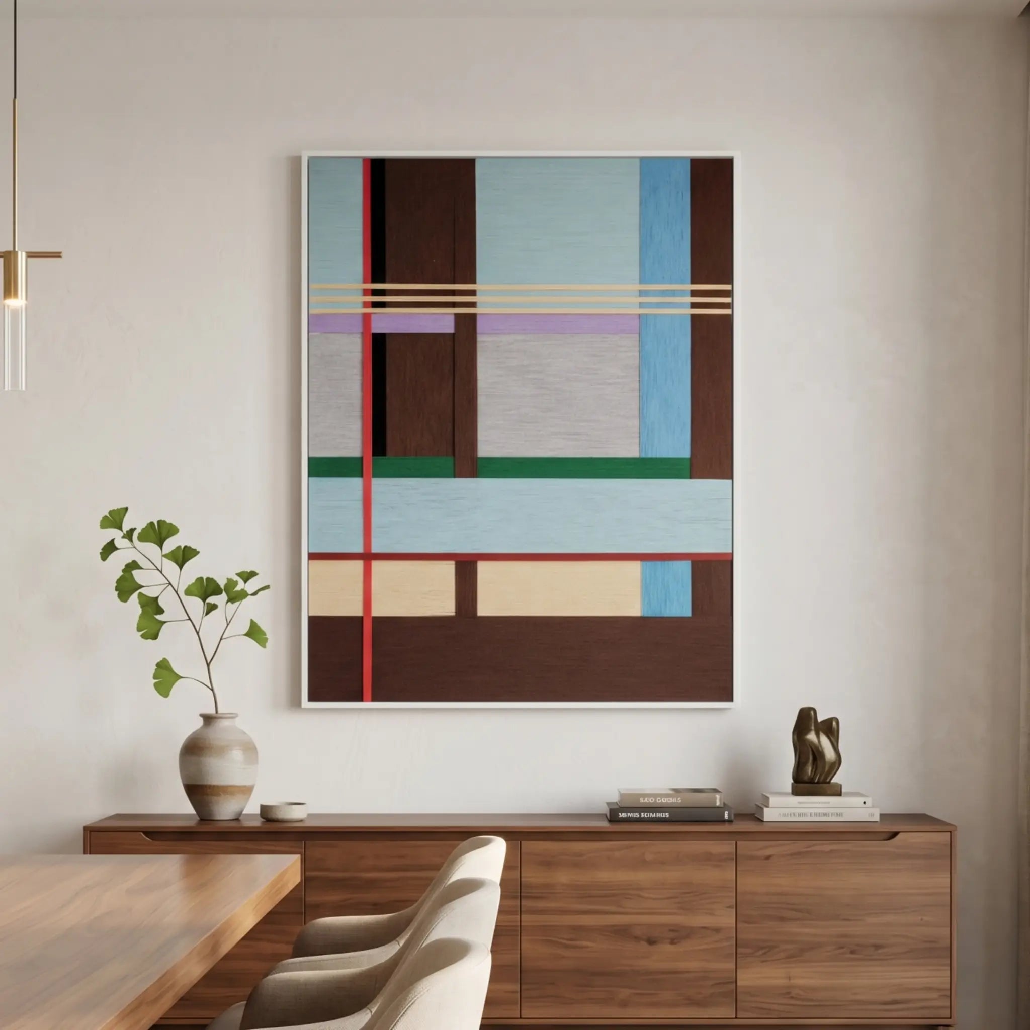 Large vertical hand-woven wool wall art featuring a complex geometric grid in light blue, mahogany, and forest green hanging above a walnut sideboard in a modern dining area.