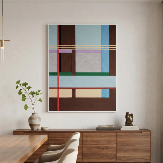 Large vertical hand-woven wool wall art featuring a complex geometric grid in light blue, mahogany, and forest green hanging above a walnut sideboard in a modern dining area.