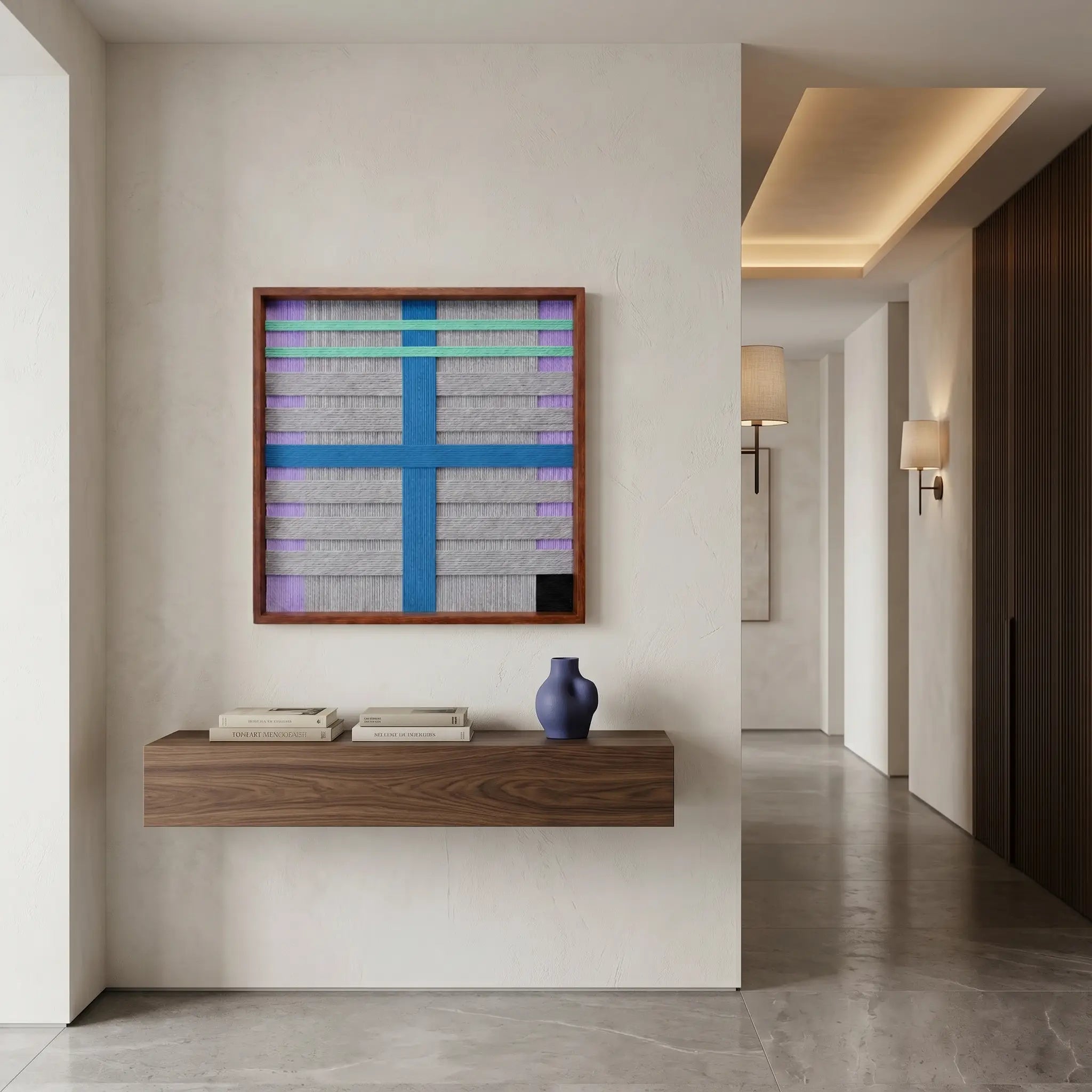 Contemporary woven wool tapestry displayed above a floating wooden console in a modern, brightly lit hallway.