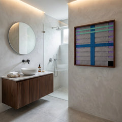 Large square Cobalt Window fiber wall art featuring a striking cobalt blue cross and mint green accents, hanging in a modern luxury bathroom with a wooden vanity.