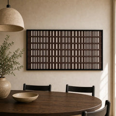 Earth-toned rhythmic hand-woven wool tapestry beautifully staged in a warm dining room, hanging over a dark round dining table and chairs.