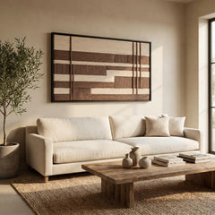 The Cocoa Grid geometric hand-woven wool tapestry provides a stunning focal point over a modern white sofa and wooden coffee table in a sunlit living space.