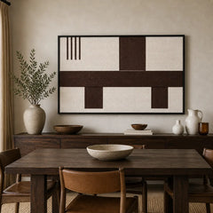 Earth-toned geometric hand-woven wool tapestry beautifully staged in a warm dining room hanging over a rustic wooden sideboard.