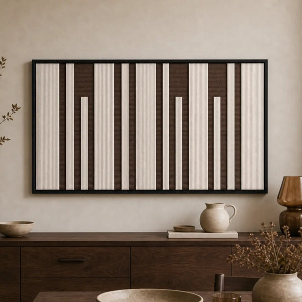 Earth-toned geometric hand-woven wool tapestry beautifully staged in a warm room, hanging over a rustic wooden sideboard.