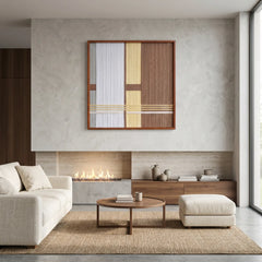 Modern hand-woven wool wall hanging styled in a luxury lounge area with a fireplace, low wooden table, and plush white furniture.