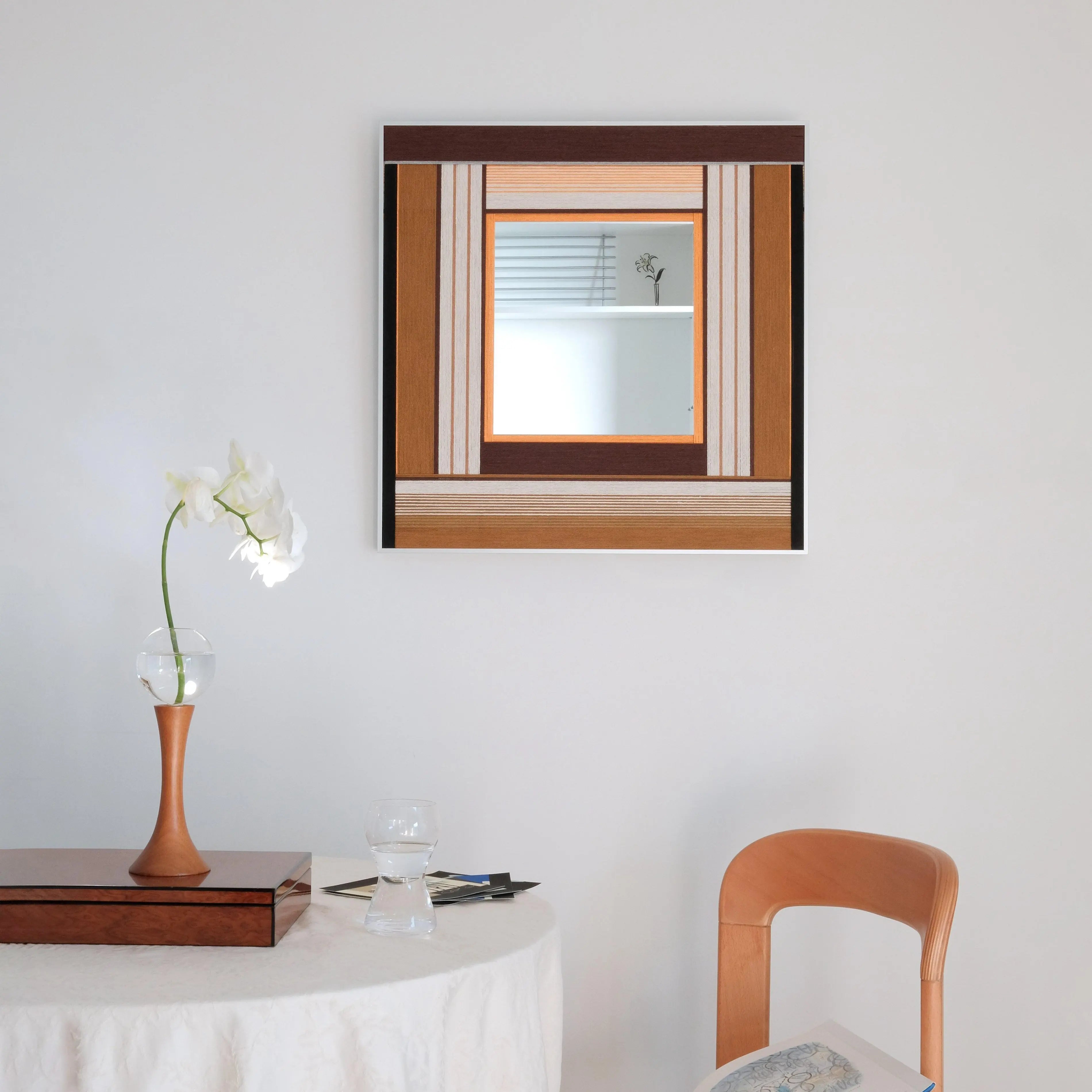 Styled dining nook featuring the Bread & Coffee textured wall art mirror, complementing the wooden furniture and soft lighting of the room.