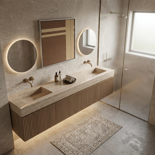 Framed fiber art tapestry with an earthy textured design displayed in a luxury bathroom featuring double sinks and circular mirrors.