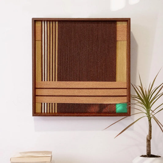 Earthy Fragrance hand-woven wool yarn wall art with alternating deep brown, tan, and emerald green vertical stripes in a natural wood frame
