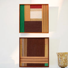 Earthy Fragrance yarn art paired with a complementary panel, featuring coordinated earth-tone stripe grids in matching wood frames
