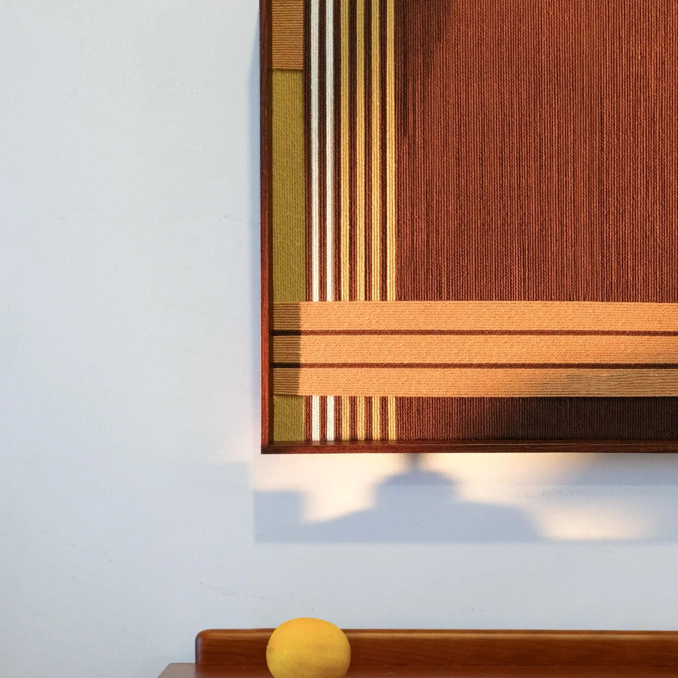 Front view of Earthy Fragrance wall art on a clean wall, highlighting its square format and warm earth-tone stripe design
