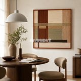 Embers of the Wild earth-tone textile wall art styled beside a round wood table in a softly lit organic modern dining room.