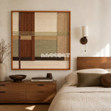 Embers of the Wild earth-tone textile wall art displayed above a wood dresser in a warm neutral bedroom.