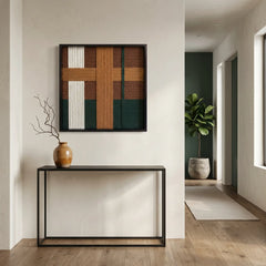 Textured wool wall art styled in a minimalist entryway above a slim black metal console table with a ceramic vase.