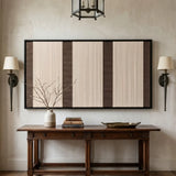 Framed Eternal Colonnade textile wall art styled perfectly above a wooden console table in a warm, inviting hallway with classic wall sconces.