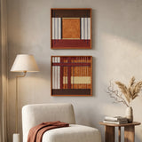 Two stacked hand-woven wool wall art pieces with orange and brown geometric patterns hanging in a sunlit modern living room.