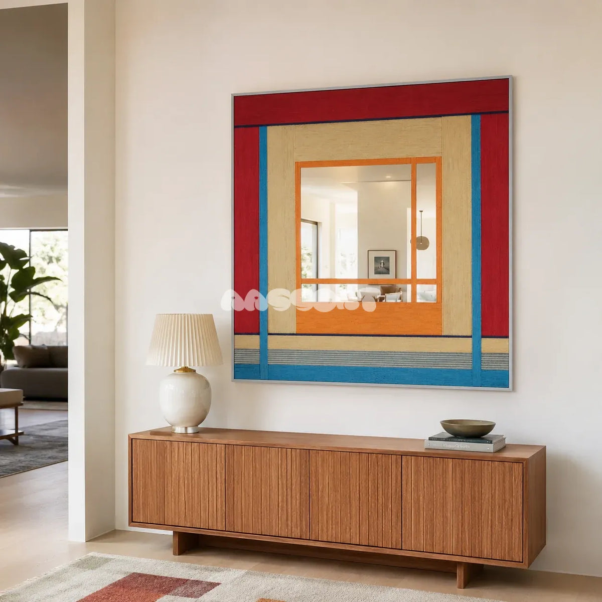 Fields of Blossoms colorful yarn-framed mirror displayed above a wood sideboard in a bright minimalist entryway.