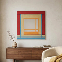 Large hand-woven wool wall art featuring red and yellow geometric patterns displayed above a wooden sideboard in a bright living room.