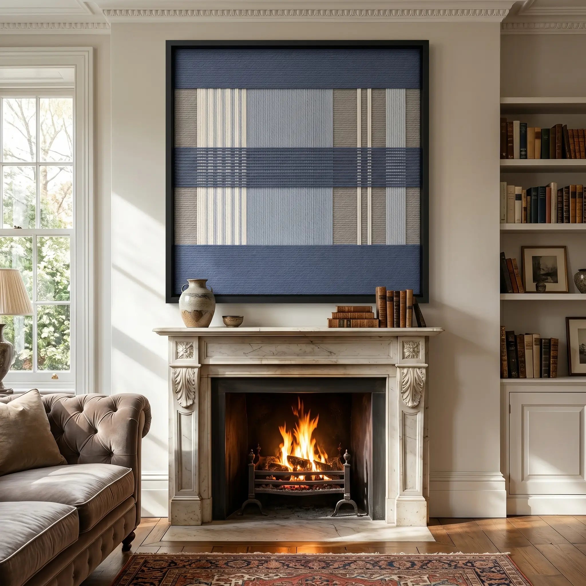 Large square Foggy Pier hand-woven wall art hanging elegantly above a classic fireplace mantel in a cozy, softly lit living room with a crackling fire.