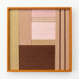 Frontal studio shot of Folded Dialogue soft cotton cord wall art featuring dusty pink and espresso geometric blocks in an oak frame.