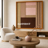Folded Dialogue pink beige and espresso textile wall art displayed above a light wood sideboard in a warm modern living room.