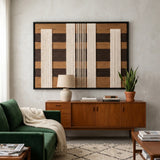 A large Forgotten Gateway framed wall art piece displayed above a mid-century wooden sideboard and green sofa in a modern living room.