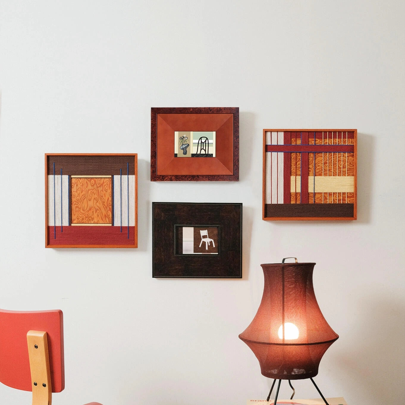 A stylish gallery wall featuring the Festive Harmony fiber art alongside other framed pieces, illuminated by a warm table lamp in a cozy room.