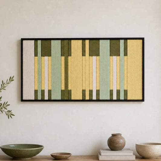 Framed Garden Interval hand-woven wall art displayed above a light wood console shelf in a serene living room setting.