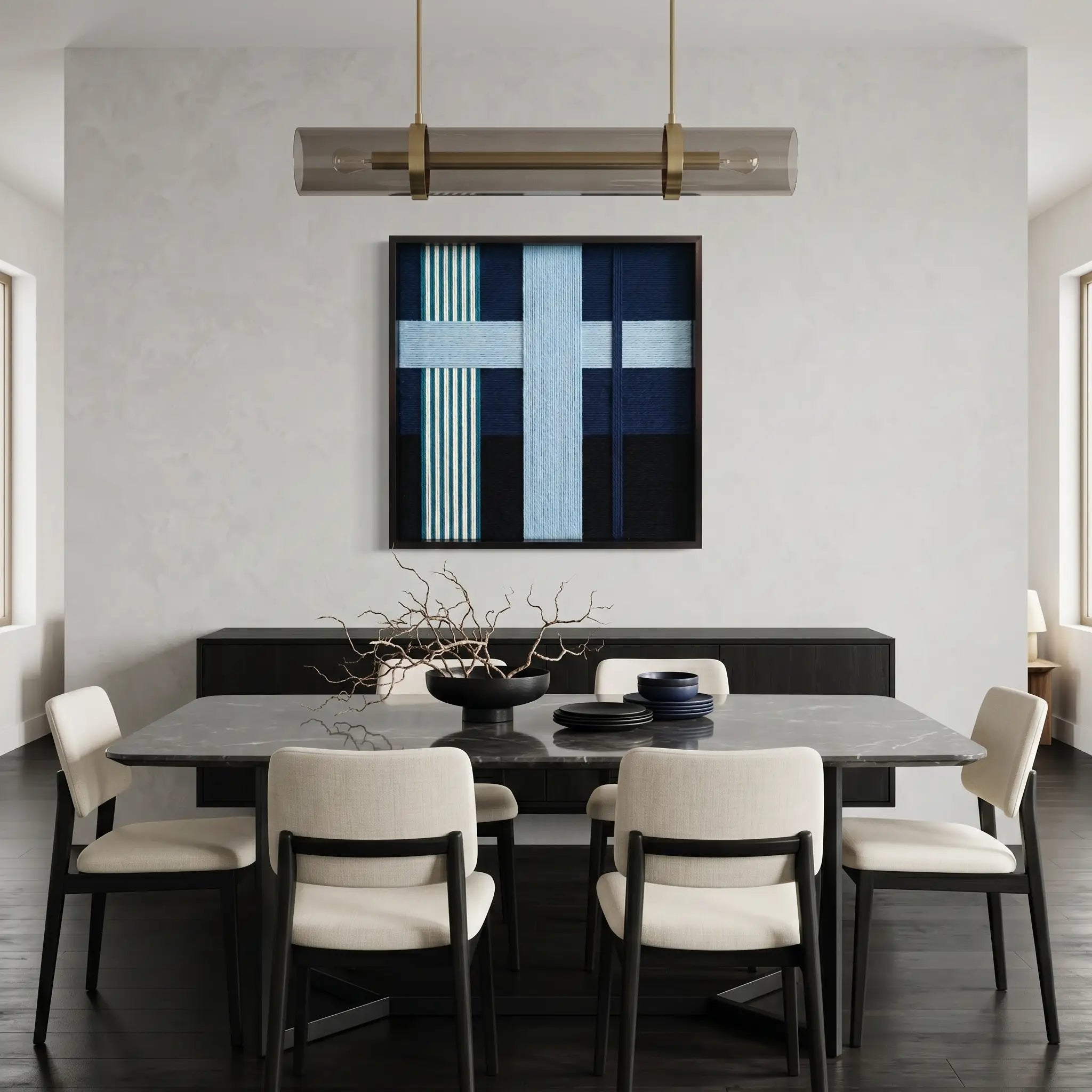 Modern blue and navy fiber wall art styled in a contemporary dining room with a dark table and white designer chairs.