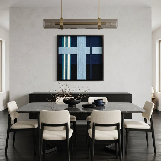 Modern blue and navy fiber wall art styled in a contemporary dining room with a dark table and white designer chairs.