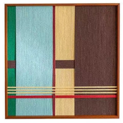 Close-up of the hand-woven wool texture featuring a split design of cool mint green and warm brown fibers with geometric lines.