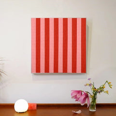Front view of Hana & Alice yarn wall art on a clean white wall, highlighting its square format and striking red stripe design
