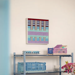 Hanosen Anji yarn wall art styled on a desk with lamp and decorative objects, highlighting its seamless pastel grid design
