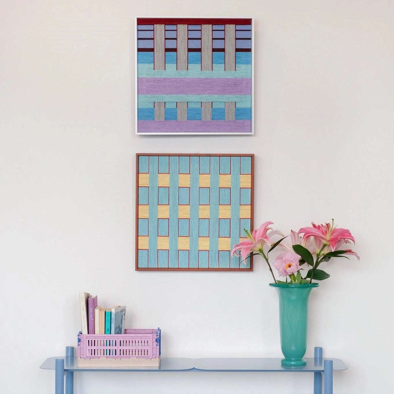 Detailed view of Hanosen Anji wall art beside a vase of flowers, highlighting its hand-woven texture and gentle color transitions
