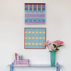 Detailed view of Hanosen Anji wall art beside a vase of flowers, highlighting its hand-woven texture and gentle color transitions
