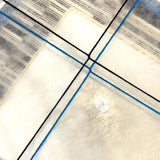 Rear construction detail of Inception SQ016 showing crossed blue and black yarn on a translucent backing.