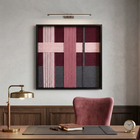Large square Lilac Whispers fiber wall art with plum, mauve, and charcoal hand-woven wool patterns hanging in a sophisticated home office above a walnut desk.