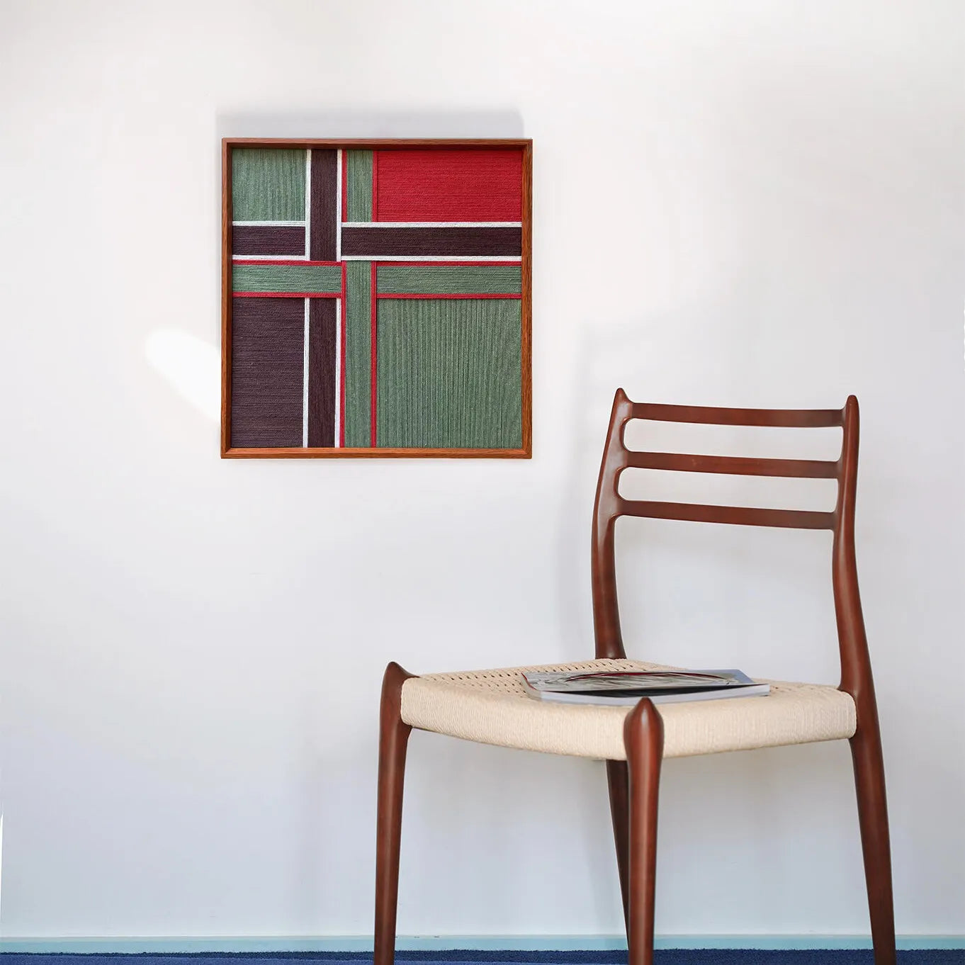 A wider perspective of the woven wall decor in a living space, perfectly sized to serve as a colorful focal point above furniture.