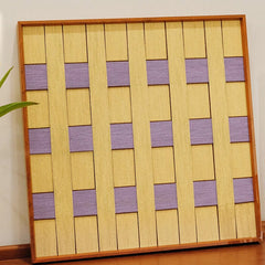 Angled close-up of Lover’s Moonlight Violet yarn wall art highlighting the tight weave at the intersection of lavender and yellow stripe panels
