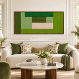 Lucerne Meadow RE061 framed fiber wall art in layered greens and pale blush above a cream sofa in a bright living room