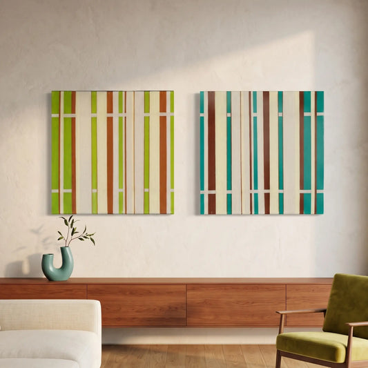 A diptych set of square hand-woven wool wall art featuring vertical earth-tone stripes in lime green, orange, teal, and brown hanging above a long walnut sideboard.