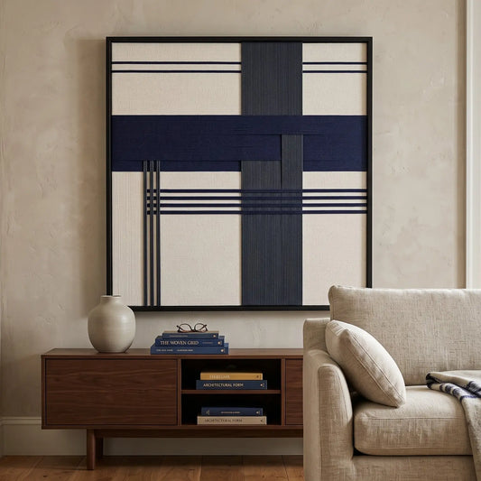 Midnight Axis framed wall art styled above a dark wood credenza in a modern living room with comfortable cream-colored seating.