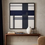 Elegant Midnight Axis textile wall art hanging above a fireplace in a cozy, sunlit room with blue furniture and hardwood floors.