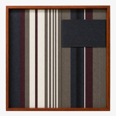 Frontal studio shot of the Midnight Fjord square hand-woven textile wall art featuring navy blue, burgundy, grey, and cream vertical stripes with a solid navy patch in a wooden frame.