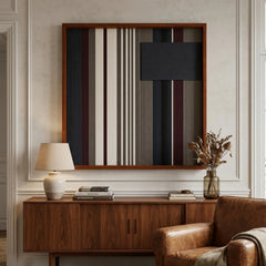 Large square Midnight Fjord hand-woven wall art hanging elegantly above a mid-century wooden credenza next to a brown leather armchair.